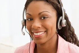CallCenterUSA receptionist smiling while answering a customer call with a headset